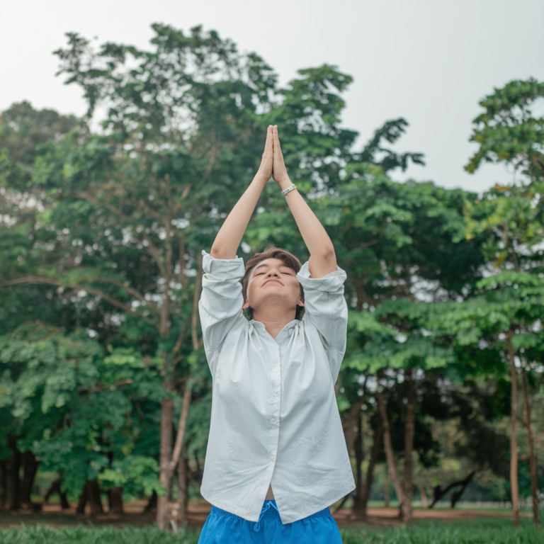 "Person practicing positive thinking with a peaceful background, symbolizing the benefits of optimism for mental and physical well-being."